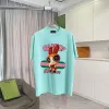 Gucci Purple T Shirt Featuring Blossom Cartoon Doll Graphic with Pink and Green Design Accents #A54263