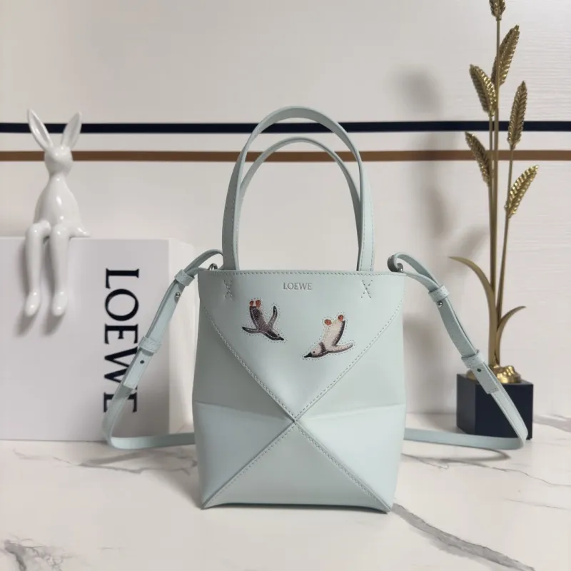 Loewe Womens Mini Bucket Bag - Light Blue Leather with Penguin Embroidery, Convertible Handle & Crossbody Strap, Playful Luxury Handbag with Anagram Logo #A56856