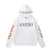 AMIRI Black/White Hoodie With Bold Logo And Orange Graphic Sleeves For Streetwear Style #A54282