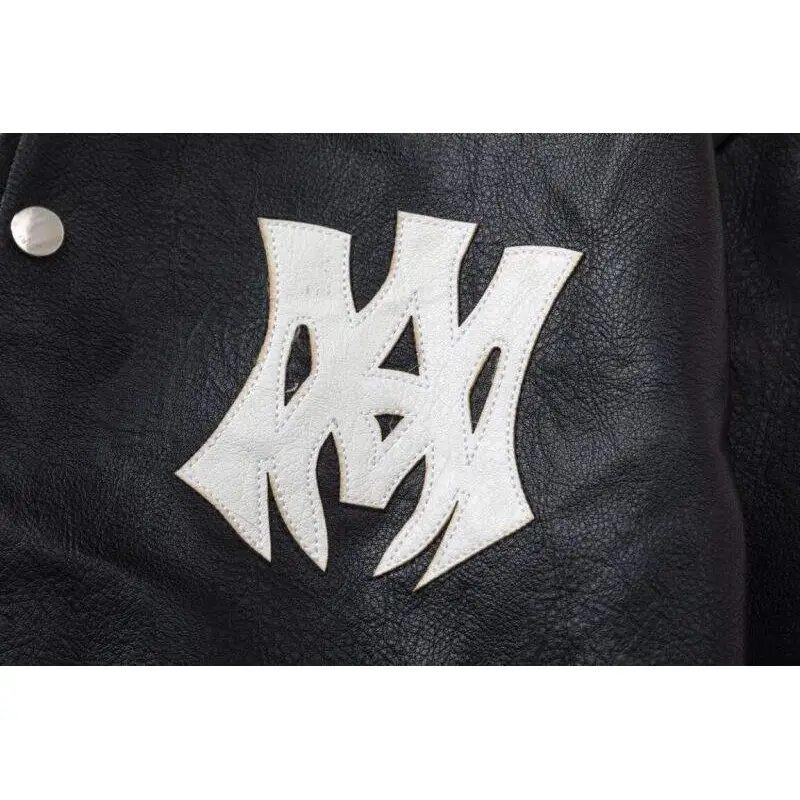 AMIRI Black Leather Bomber Jacket With Iconic Logo And Varsity Stripe Details #A54436 AMIRI Black Leather Bomber Jacket With Iconic Logo And Varsity Stripe Details #A54436