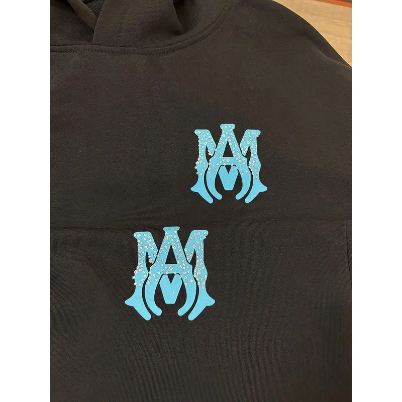 AMIRI Black Hoodie With Glittery Blue Back Logo And Brand Details #A54287 AMIRI Black Hoodie With Glittery Blue Back Logo And Brand Details #A54287