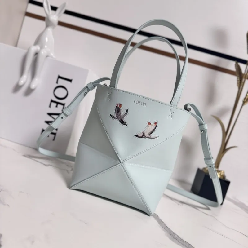 Loewe Womens Mini Bucket Bag - Light Blue Leather with Penguin Embroidery, Convertible Handle & Crossbody Strap, Playful Luxury Handbag with Anagram Logo #A56856