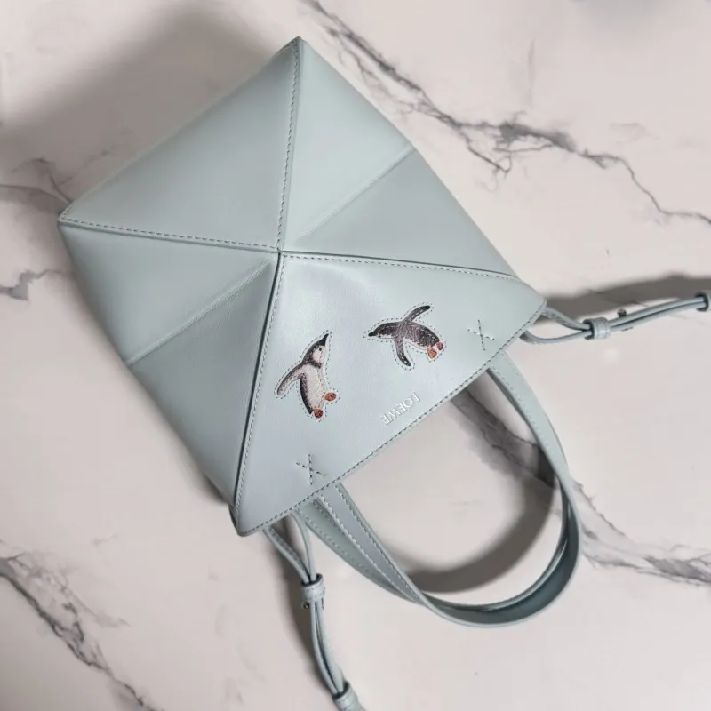 Loewe Womens Mini Bucket Bag - Light Blue Leather with Penguin Embroidery, Convertible Handle & Crossbody Strap, Playful Luxury Handbag with Anagram Logo #A56856