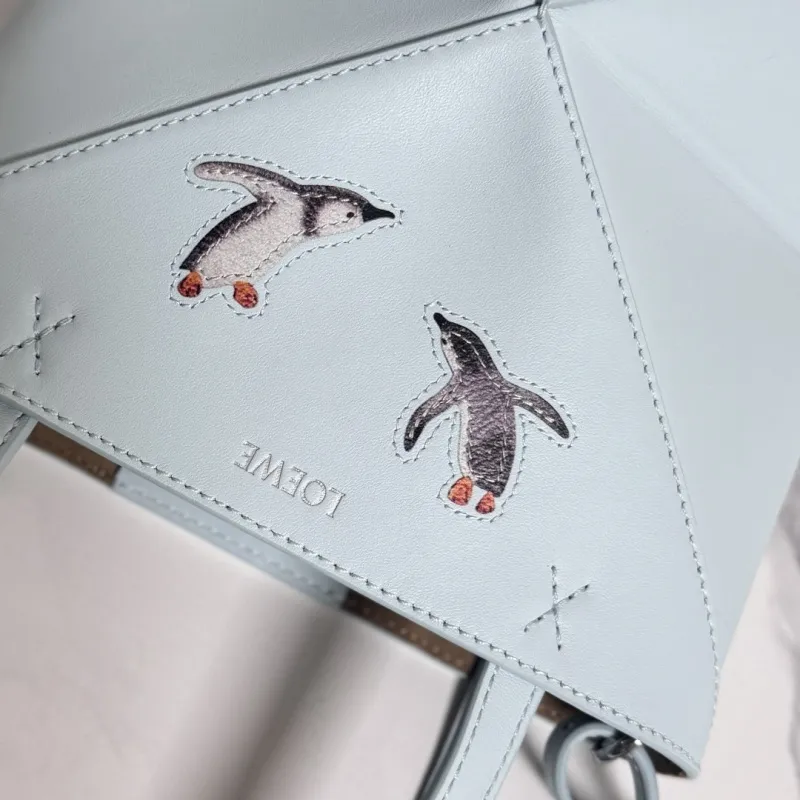 Loewe Womens Mini Bucket Bag - Light Blue Leather with Penguin Embroidery, Convertible Handle & Crossbody Strap, Playful Luxury Handbag with Anagram Logo #A56856