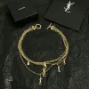 Saint Laurent Cassandre Multi Layer Logo Charm Gold Choker Necklace for Women #A65948 Saint Laurent Cassandre Multi Layer Logo Charm Gold Choker Necklace for Women #A65948